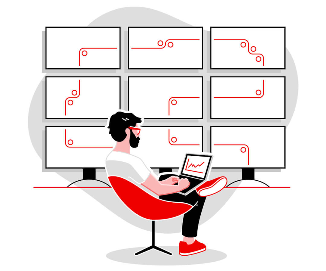 Person casually sitting in red chair working from desktop with 9 monitors connecting in backdrop